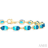 6X4 MM Oval Cut Blue Topaz and 1/6 Ctw Round Cut Diamond Semi-Precious Tennis Bracelet in 10K Yellow Gold