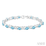7x5 mm Oval Cut Blue Topaz and 1/20 Ctw Round Cut Diamond Fashion Bracelet in Sterling Silver